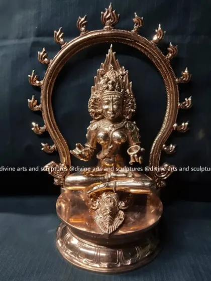 A finished bronze sculpture of Kalika, a fierce form of Kali. She is depicted seated on a symbolic corpse, framed by a halo of flames, representing her power over time and destruction.