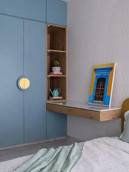 Designing for children means creating a space that is both fun and functional. This daughter's bedroom features a custom C-shaped platform bed, pastel blue arched wardrobes for smart storage, and a rustic brick wall, showing how I tailor each kids' room design to the child's personality.