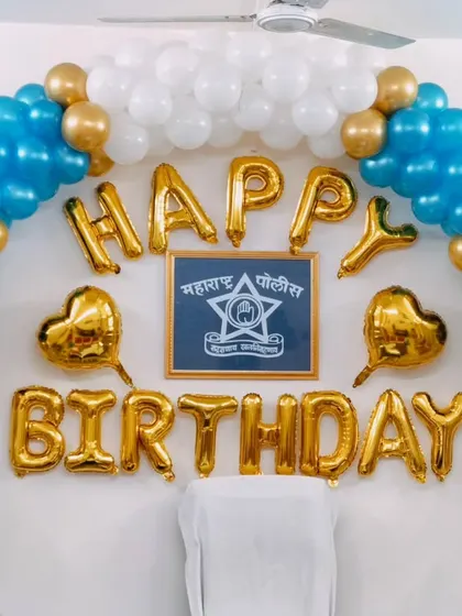 A special birthday celebration for a police officer, with a balloon arch in themed colors and the department's insignia.