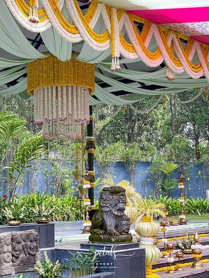 A detail shot of the traditional decor, including a stone lion statue and beautiful floral arrangements.