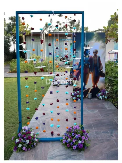 A creative entrance piece made of hanging floral strings, creating a colorful curtain for guests to walk through.