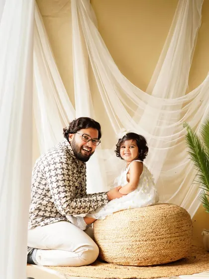The bond between a father and his daughter is so special. This candid shot captures a moment of shared laughter and joy during their family studio session.