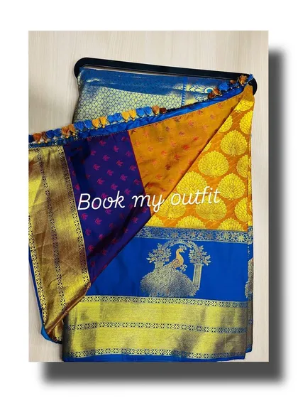 Another one of my beautiful silk sarees available for rent, this one in a striking blue and yellow combination with a woven peacock motif.