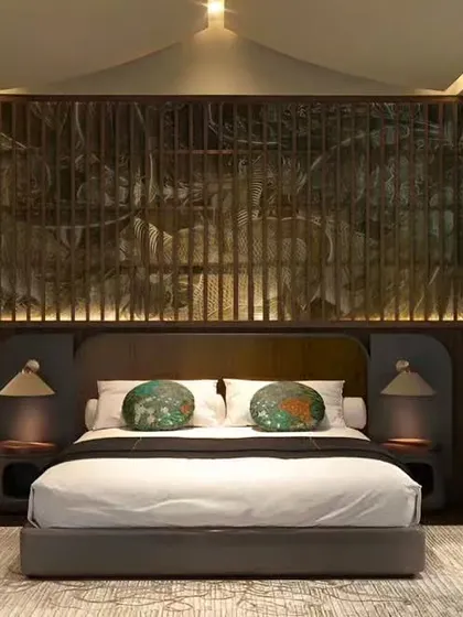 A striking bedroom design featuring a custom-paneled headboard and an ornate wooden screen. This setup showcases our ability to blend intricate details with modern furniture for a unique, luxurious feel.