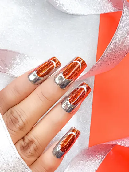 Another angle of the orange jelly and chrome nails, showing the clean lines and high-shine finish.