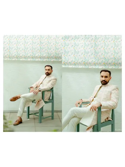 A modern and stylish portrait of the groom, seated and looking sharp in his wedding attire. The clean background and confident pose make for a great shot.