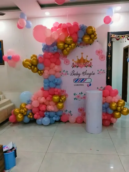 The complete "Baby Loading" baby shower setup, ready for the event. The pillar next to the backdrop can be used for placing a cake or gifts.