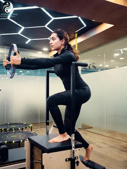 Using the stability chair, this client works on balance and leg strength. This piece of equipment is highly versatile and can be adapted for all fitness levels, from beginners to advanced.