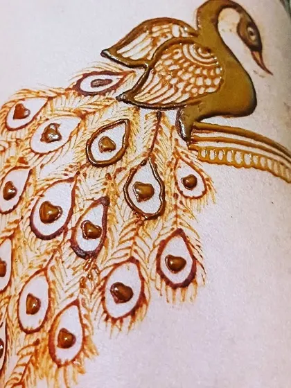 A close-up of a peacock detail. It's all about the fine lines and shading to bring these beautiful birds to life in my henna art.