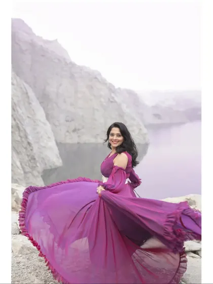 The unique wine-blue dual-shaded gown is perfect for a creative pre-wedding shoot, offering a beautiful play of colors as you move.