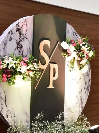 A modern, circular backdrop with the couple's initials. We create custom props like this to personalize your event.