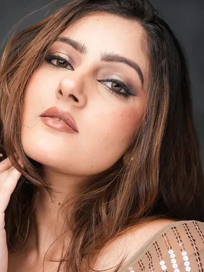 This angle shows the beautiful dimension created with contour and highlight, complementing the dramatic eye makeup.