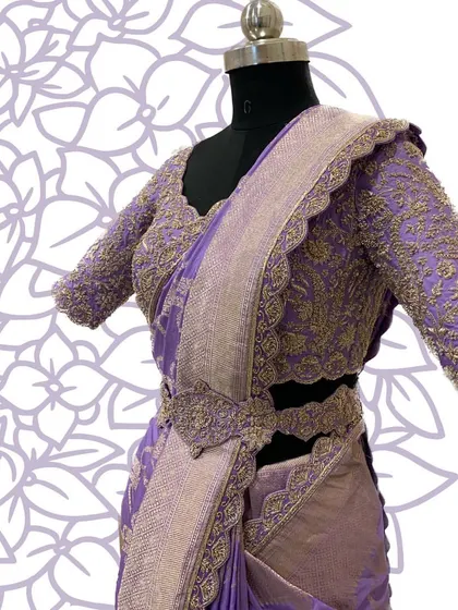 A side view of the lavender saree set, highlighting the embroidered belt and scalloped edges.