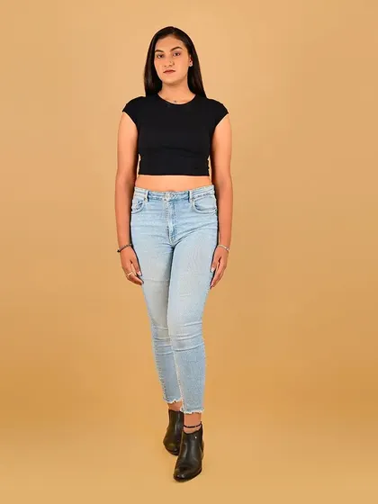 A front-facing, full-length digital. The makeup is clean and professional.