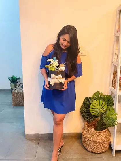Our founder in her element, surrounded by the beautiful products and decor that go into our curated gift hampers.