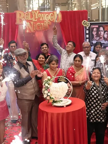 The cake-cutting ceremony, surrounded by family and friends with sparklers, creating a magical, celebratory moment.