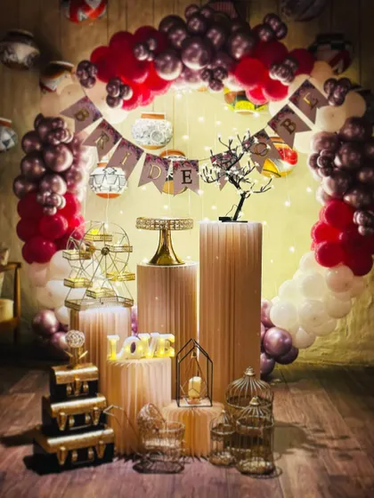 A clearer view of the red and chrome birthday setup, showing the mix of a birthday banner and decorative lanterns.
