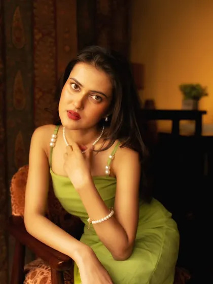 A beautiful, classic portrait pose. The soft focus on the background helps the subject stand out, even in a detailed room.