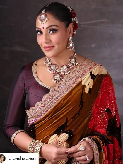 A stunning solo portrait of Bipasha Basu, showcasing her elegance in a traditional Torani official outfit for a festive occasion.