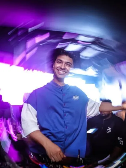 A happy, candid moment from a night at Vault in Pune. The swirly lights capture the dizzying fun of the party.
