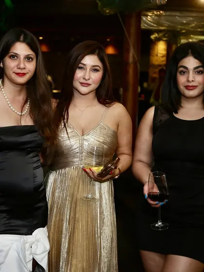 The glamorous attendees of the Polo Season celebration, enjoying a night of drinks and conversation.