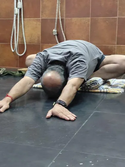 A forward-bending variation of Malasana (Garland Pose), releasing the lower back.