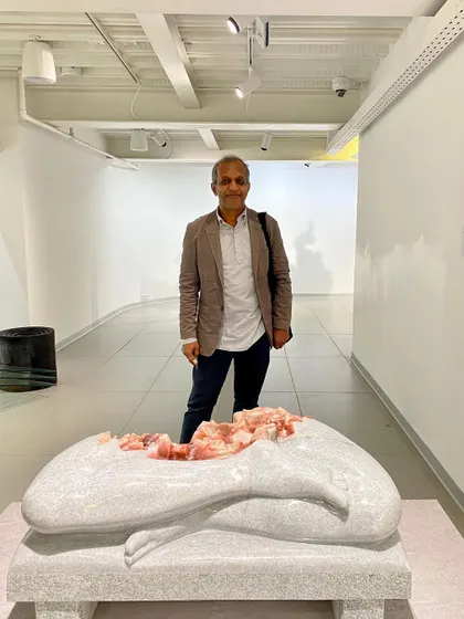 Artist L.N. Tallur stands with his work at the museum preview. My goal is to create spaces where artists feel their work is understood and presented with integrity.