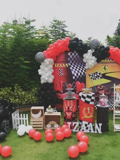 A high-octane Ferrari race car theme, perfect for a little speed enthusiast. The setup includes a race track backdrop and checkered flag details.