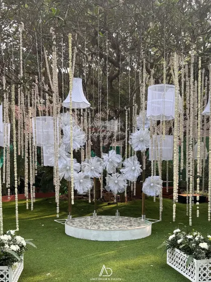 A full view of the artistic backdrop with origami flowers and hanging lampshades, designed to be a stunning and interactive photo installation.
