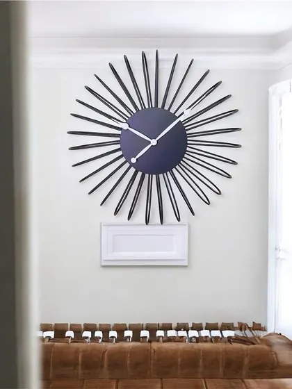 A sunburst clock with clean, simple lines, offering a modern take on a classic mid-century design.