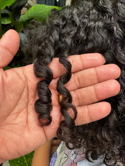 Look at that perfect spiral! A close-up of the healthy, defined ringlets after a kids' curly haircut. My goal is to enhance these natural patterns.