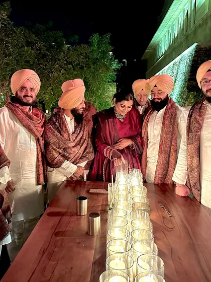 Another group shot of the band, gathered around a beautifully lit table after a show.