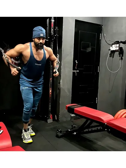 Hard work isn't an option, it's a necessity. Executing a standing cable fly to sculpt the chest.