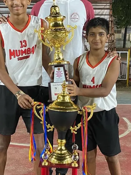 Two of our Ring Champions players, Jordan and his teammate, holding the trophies after the state championship win.