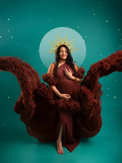 An artistic portrait with flowing fabric that mimics wings. The celestial background and golden halo give this image a divine and otherworldly feel.