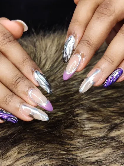 This set combines 3D chrome art with purple accents, creating a dramatic and artistic manicure on stiletto nails.