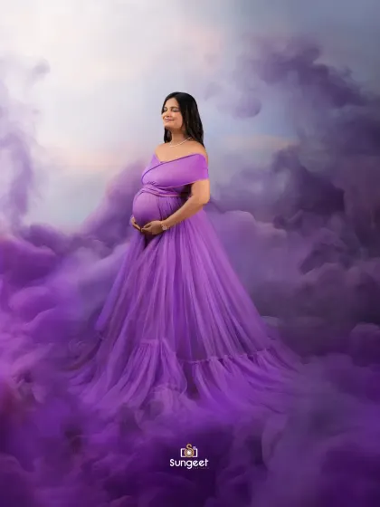 Floating on a cloud of purple smoke, this portrait creates a dreamy and ethereal mood. The off-shoulder purple gown adds to the romantic feel.