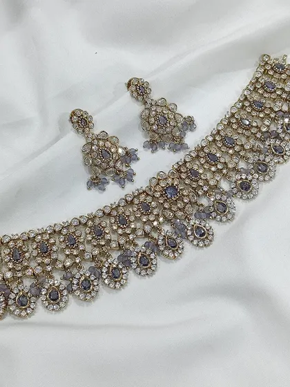 A beautiful choker set with a delicate design, shown in multiple pastel colors including grey, pink, and mint green.