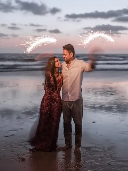 A festive Diwali-themed pre-wedding shoot on the beach, using sparklers to create a magical effect.