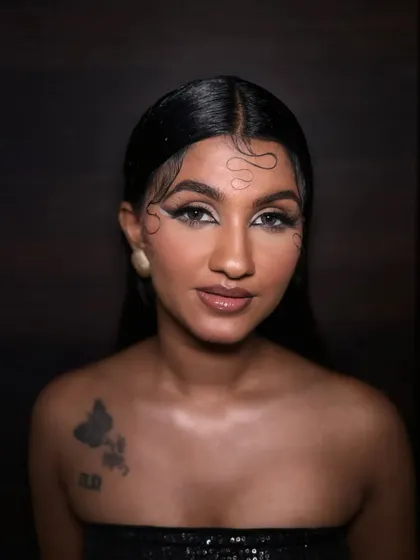 A direct portrait of the airbrush glam look. This image clearly shows the sharp, artistic eyeliner and the glowing, seamless skin finish.