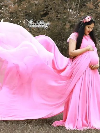The flowing fabric of our pink maternity gown looks magical as it catches the breeze, perfect for creating ethereal photos.