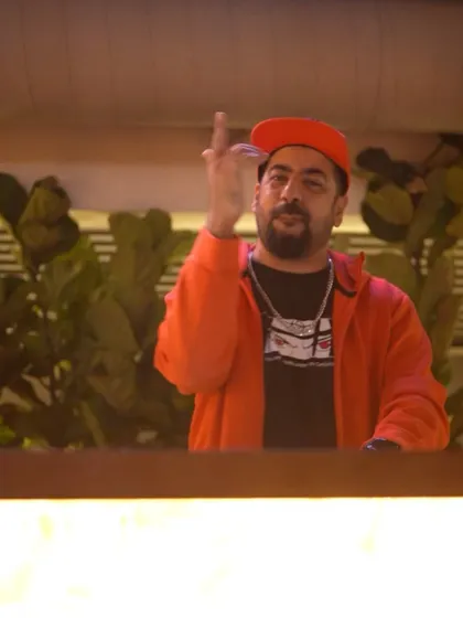 Hyping the crowd from the DJ booth at Pangeo.