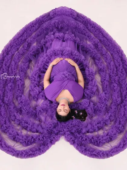 Our signature overhead "sleeping pose" in a magnificent purple ruffled gown arranged to form a heart. This is a truly unique and artistic studio shot.