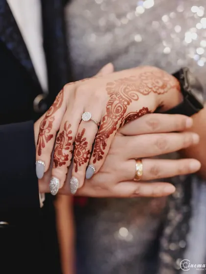 A close-up of the hands and rings, a simple yet powerful symbol of commitment captured during the engagement ceremony.