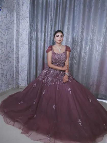 A seated portrait showing the grand sweep of the gown's skirt, making it look like a royal dress.