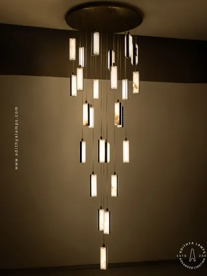 These modern pendants feature a unique combination of translucent marble and stitched leather accents. The warm light glows through the marble, creating a sophisticated and texturally rich fixture for contemporary spaces.