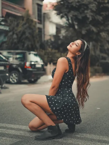 Soaking in the sun. This shot uses the natural light and the simple street setting to create a warm, carefree portrait.