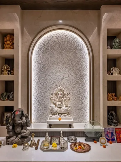 We design sacred spaces that are both modern and serene. This pooja room features an intricately carved marble backdrop with soft backlighting, creating a peaceful and divine focal point within the home.