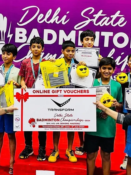 A group of our smiling champions holding their certificates and prizes at the Delhi State Badminton Championships. This image captures the joy and reward of their hard work.