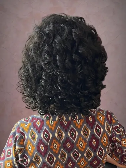 The back view shows the fullness and health of the curls after the cut.
